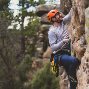 AMGA guide Dan demonstrating proper technique for clipping a bolt in a lead sport climbing course.