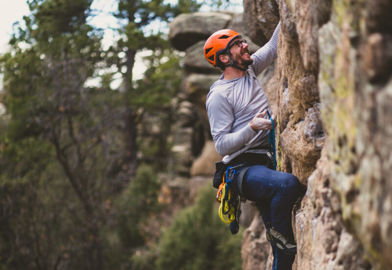 AMGA guide Dan demonstrating proper technique for clipping a bolt in a lead sport climbing course.